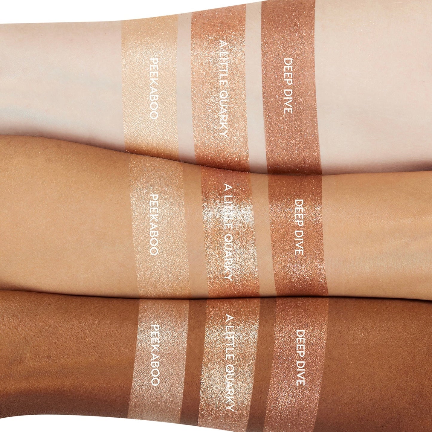 ColourPop A Little Quarky Super Shock Shadow swatched on light, medium, and deep skin, shown between Peekaboo and Deep Dive; warm champagne metallic shimmer with high shine and creamy texture, displayed in trio arm swatches for shade comparison.