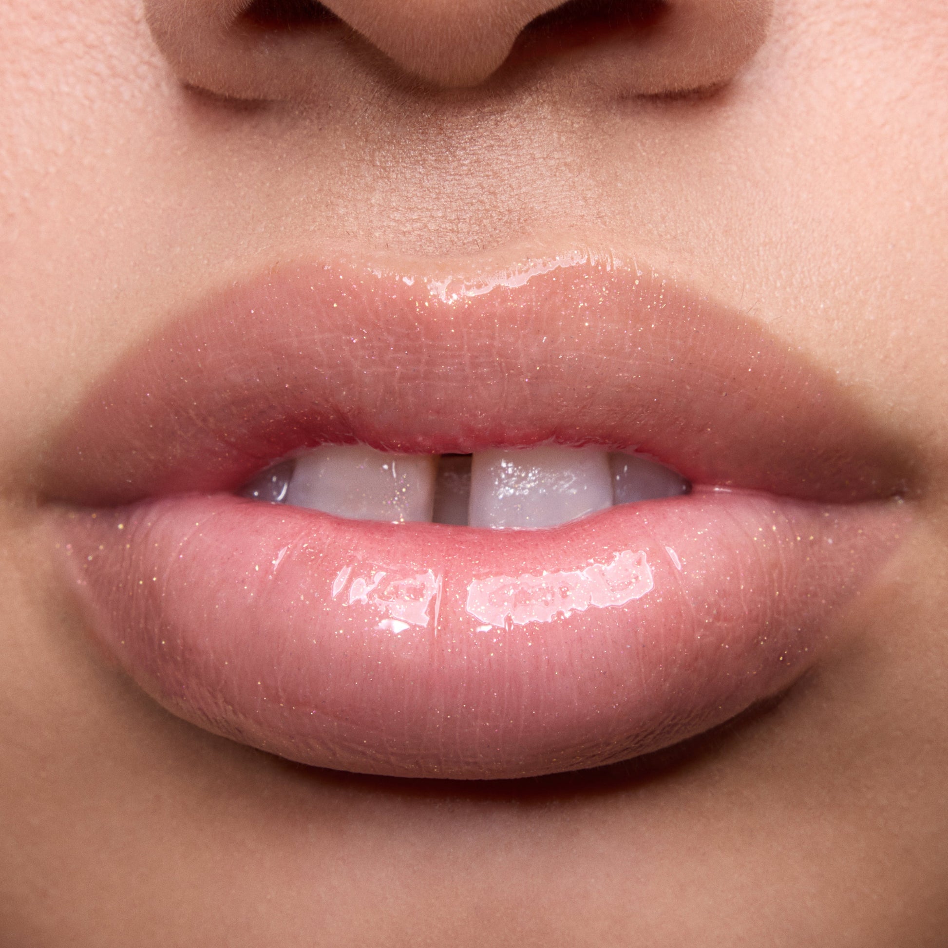 Close-up swatches of Colourpop Peach Mochi Fresh Kiss Glossy Balm on models’ lips, showing sheer peachy shimmer and high-shine finish, highlighting how this Lip Gloss & Lip Oil hybrid looks on different skin tones.