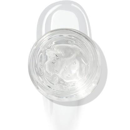 In The Clear Face & Eye Gloss in an open round jar gleams with a glossy swipe beneath it on a white background, showcasing the ColourPop Face & Eye Gloss for dewy, glass-skin shine on lids and cheeks.